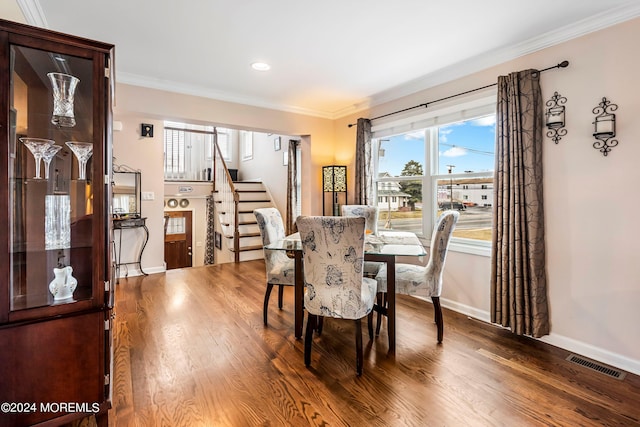 dining area with stairs, wood finished floors, visible vents, and ornamental molding