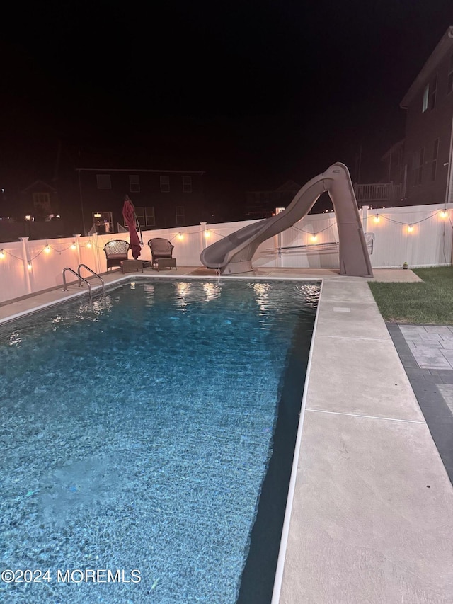 pool at night with a water slide