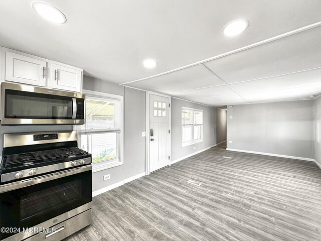 kitchen featuring light hardwood / wood-style flooring, white cabinetry, and appliances with stainless steel finishes