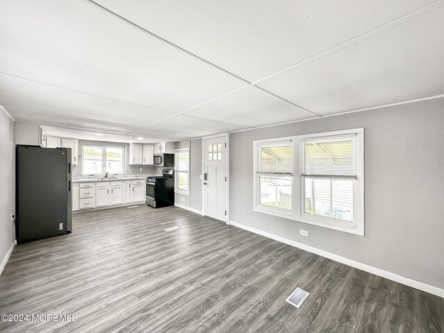 unfurnished living room featuring light hardwood / wood-style floors and sink