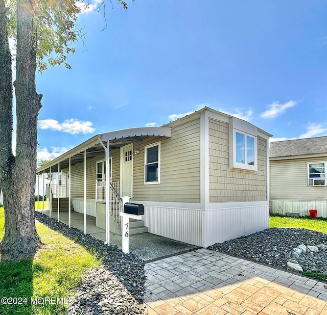 manufactured / mobile home with a patio and cooling unit