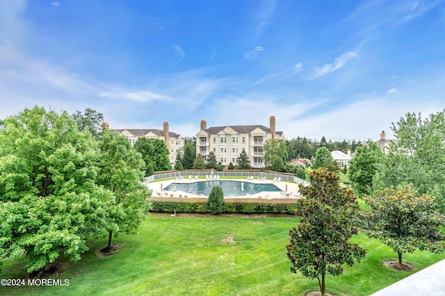 view of pool featuring a yard