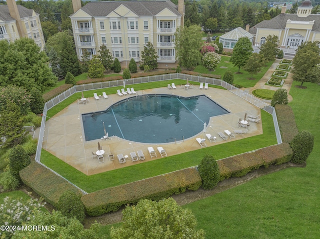 view of pool with a yard and a patio