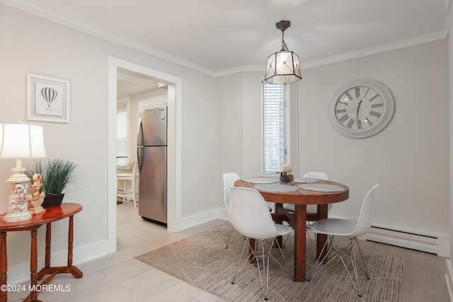 dining area featuring ornamental molding and a baseboard heating unit