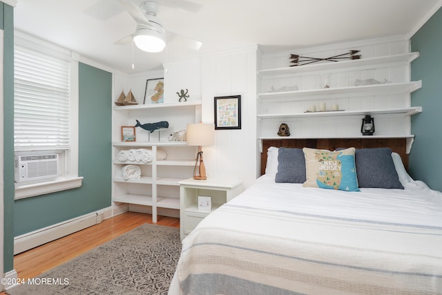 bedroom with ceiling fan, a baseboard heating unit, crown molding, cooling unit, and light wood-type flooring