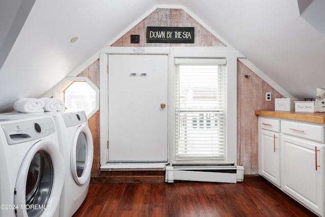 clothes washing area featuring washing machine and dryer, dark hardwood / wood-style flooring, and a baseboard heating unit