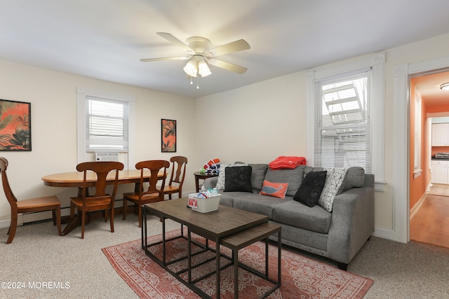 carpeted living room featuring ceiling fan and a wealth of natural light