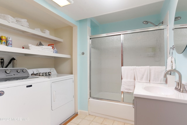 bathroom with tile patterned floors, enclosed tub / shower combo, independent washer and dryer, and vanity