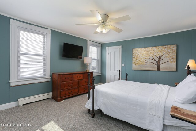 carpeted bedroom with ceiling fan, crown molding, multiple windows, and a baseboard radiator