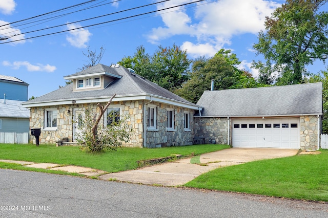 view of front of property featuring a garage and a front lawn