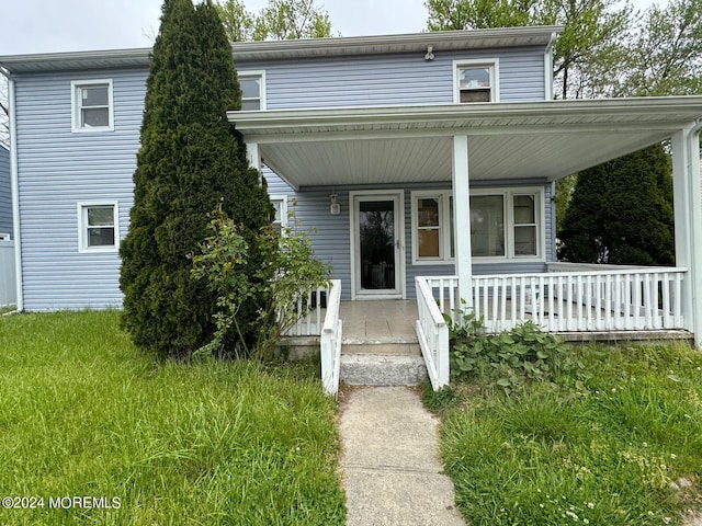 view of front of house with a porch and a front yard