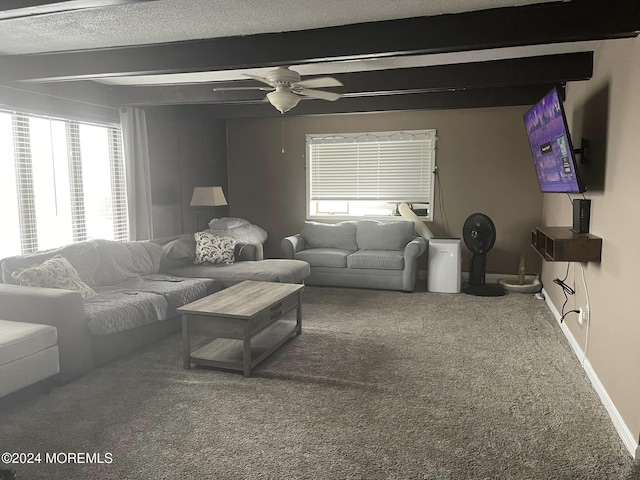 carpeted living room with a textured ceiling, ceiling fan, and beamed ceiling