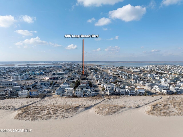 aerial view with a water view and a view of the beach