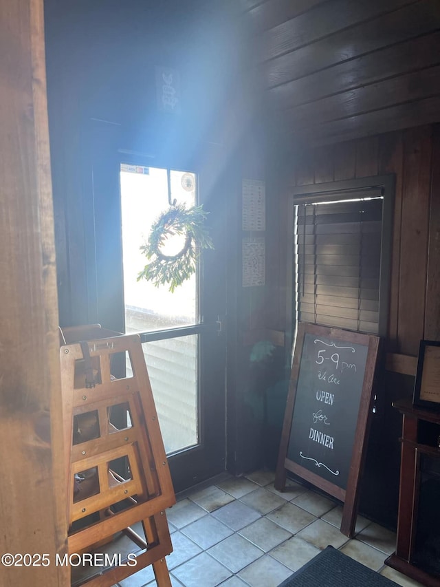 tiled foyer with wooden walls