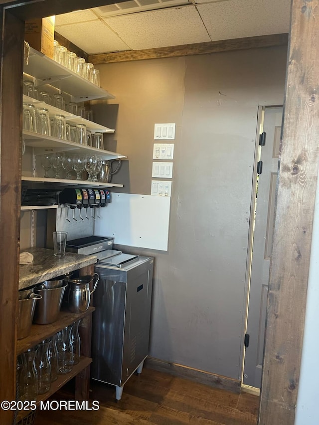 kitchen featuring a drop ceiling and dark hardwood / wood-style floors