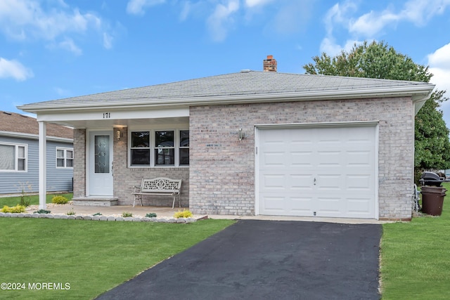 ranch-style home with a front yard and a garage