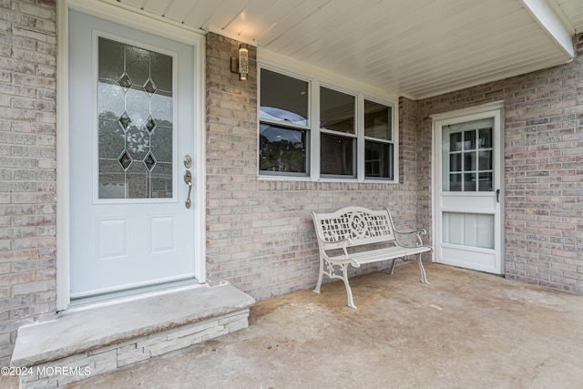 doorway to property featuring covered porch