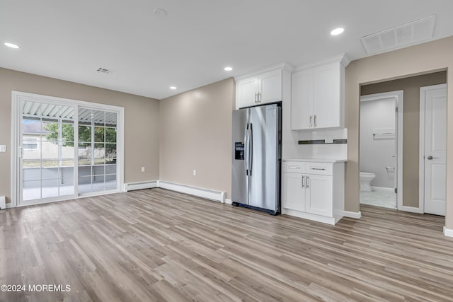 kitchen with a baseboard heating unit, light wood-type flooring, stainless steel fridge with ice dispenser, and white cabinetry