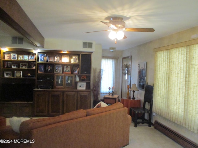 living room featuring ceiling fan, light colored carpet, and a baseboard radiator