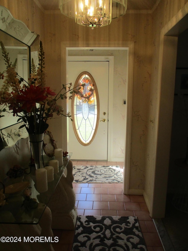 tiled foyer entrance with a chandelier