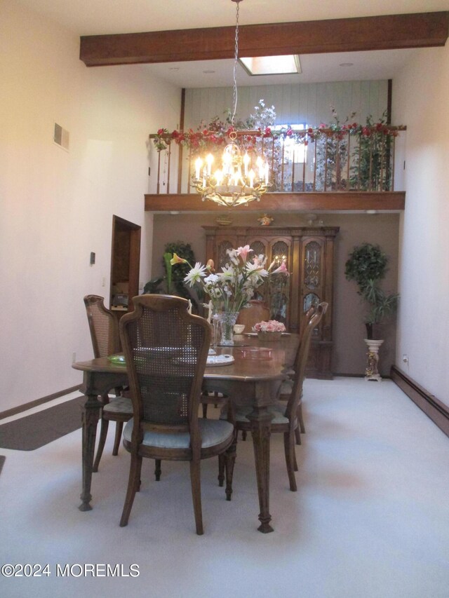 dining space featuring carpet and an inviting chandelier