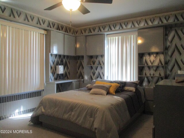 bedroom with radiator and ceiling fan