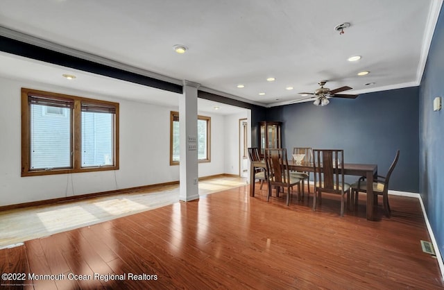 dining room with wood finished floors, visible vents, baseboards, recessed lighting, and crown molding