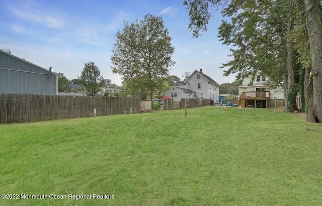 view of yard with a wooden deck and fence