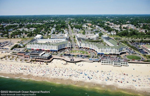 bird's eye view with a water view and a view of the beach