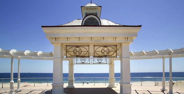 exterior space featuring a view of the beach and a water view