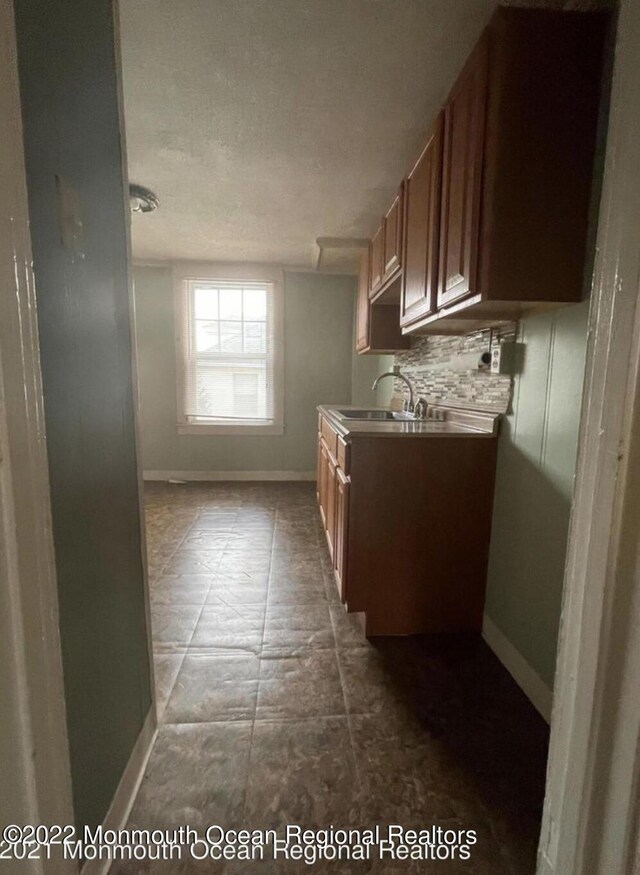 kitchen featuring a textured ceiling and sink