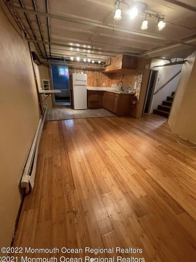 interior space with a baseboard radiator and light wood-type flooring