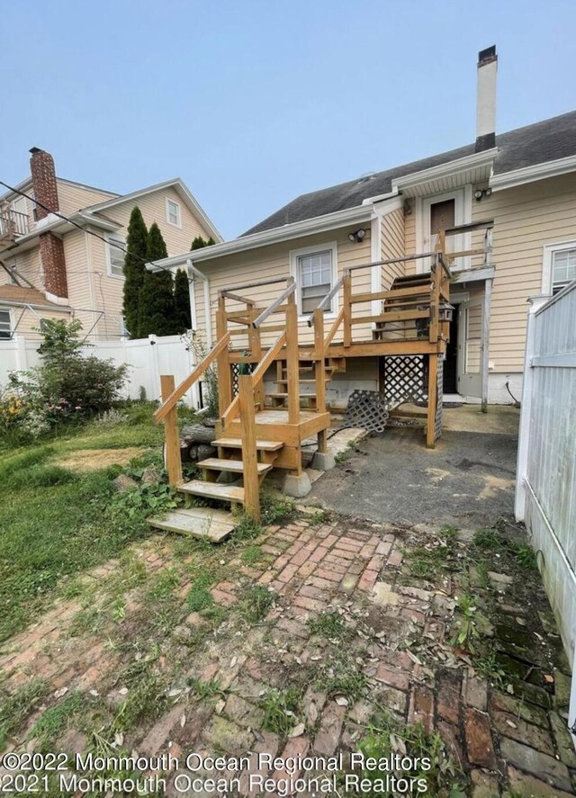 back of property with a patio and a deck