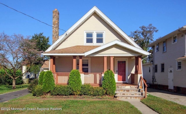 bungalow featuring a porch and a front yard