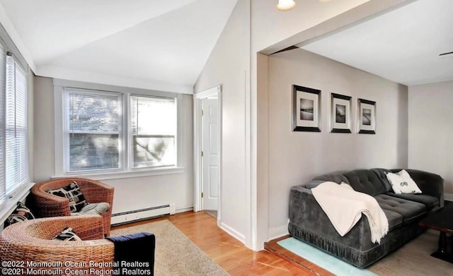 living area featuring light hardwood / wood-style floors, vaulted ceiling, and a baseboard radiator