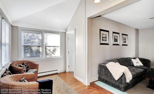 52 Liberty St, Long Branch, NJ 07740 - living room featuring a baseboard radiator, light wood finished floors, vaulted ceiling, and baseboards