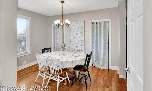 dining room featuring an inviting chandelier and light hardwood / wood-style floors