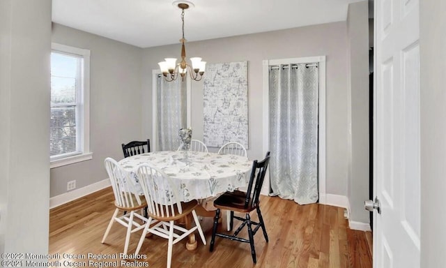 52 Liberty St, Long Branch, NJ 07740 - dining area with a chandelier, baseboards, and wood finished floors