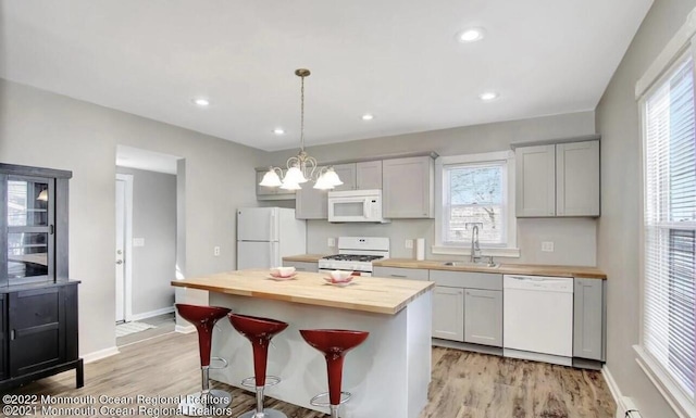 52 Liberty St, Long Branch, NJ 07740 - kitchen with white appliances, butcher block countertops, a sink, light wood finished floors, and a kitchen island