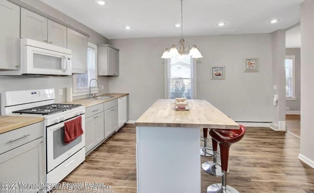 52 Liberty St, Long Branch, NJ 07740 - kitchen with white appliances, a baseboard heating unit, a kitchen breakfast bar, a kitchen island, and wood counters