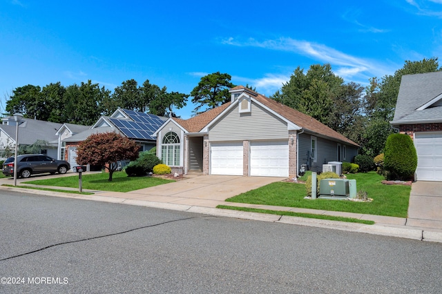 view of front of house with a front lawn, a garage, and central air condition unit