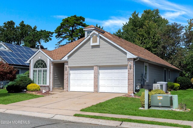 view of front of home featuring a garage and a front yard