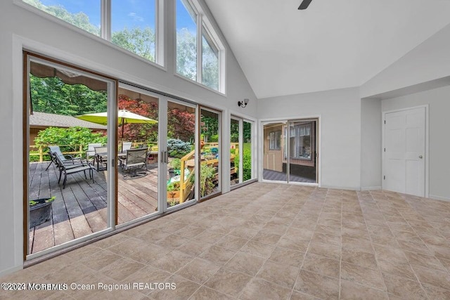 unfurnished sunroom featuring lofted ceiling