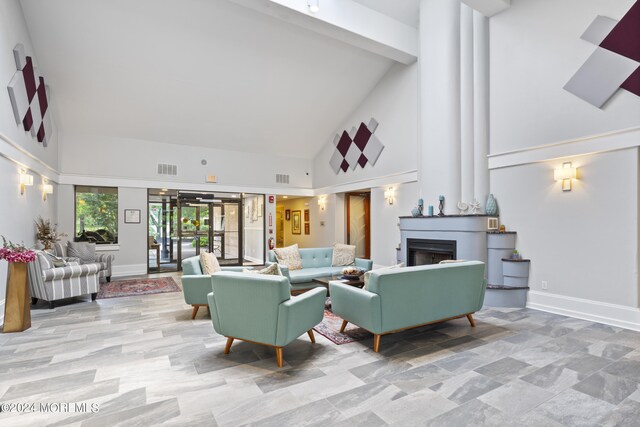 living room featuring high vaulted ceiling