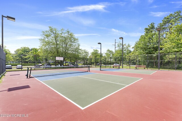 view of sport court featuring basketball hoop