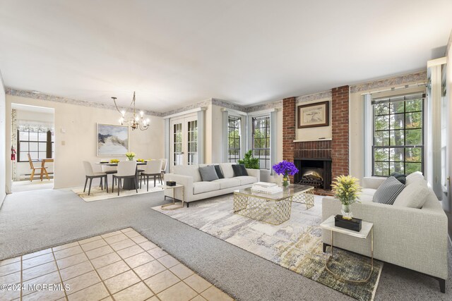 living room with a healthy amount of sunlight, a fireplace, and light carpet