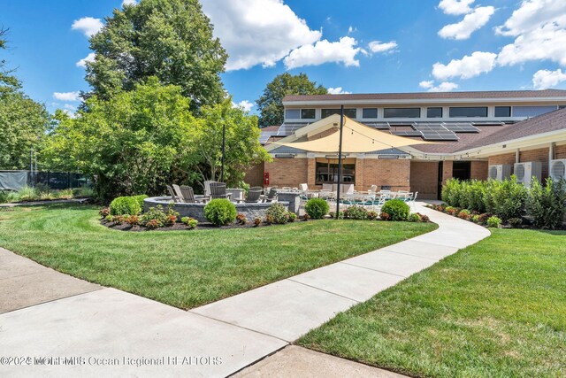 exterior space featuring a front yard and a patio