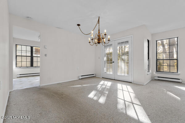 interior space with a baseboard radiator and a healthy amount of sunlight