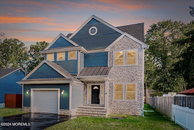 view of front of house featuring a garage and a yard