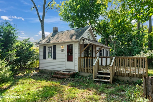 rear view of house featuring a deck